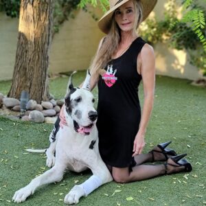 A woman and her dog pose for the camera.